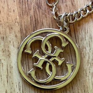 GUESS Silver Tone Circular Designer Metal Logo Purse Charm